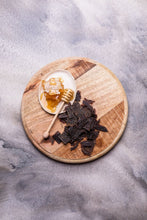 Load image into Gallery viewer, Kooee! Manuka Honey Beef Jerky placed on timber board next to raw honeycomb
