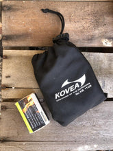 Load image into Gallery viewer, Kovea stove in carry bag next to a packet of matches to highlight small size