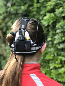 Young female wearing head torch, view from back of head