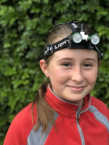 Young female wearing head torch