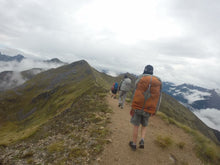 Load image into Gallery viewer, Young male wearing Aarn Natural Balance Pack hiking in New Zealand