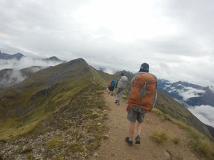 Young male wearing Aarn Natural Balance Pack hiking in New Zealand