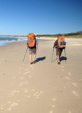 Load image into Gallery viewer, Two males wearing full hiking packs walking on the beach