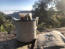 Load image into Gallery viewer, The Laughing Pug Coffee Drip Bag in mug-coffee brewing-at campsite