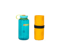 Load image into Gallery viewer, NEMO Tensor Insulated 20R Mat deflated and rolled up beside a Nalgene bottle to show small packed size