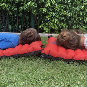 Two children laying on NEMO Cosmo Insulated Sleeping Mats 